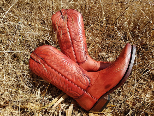 Women's and men's Cowboy boots in orange leather and country brick