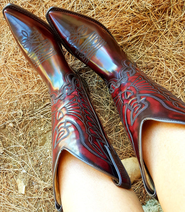 Women's and men's Cowboy boots in handmade leather and shiny dark red varnish